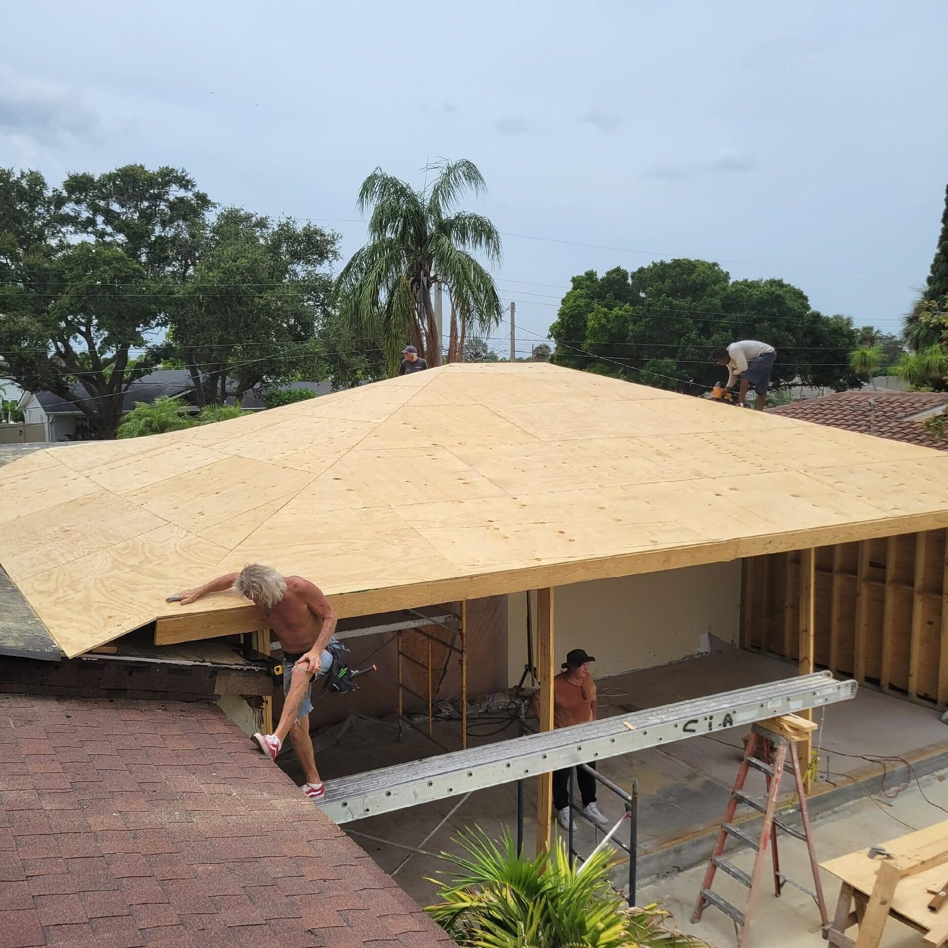 Reliant crew sheathing the roof of a home addition