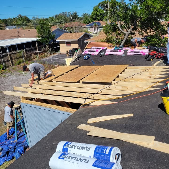 Reliant roofing crew tearing off and re-decking a roof