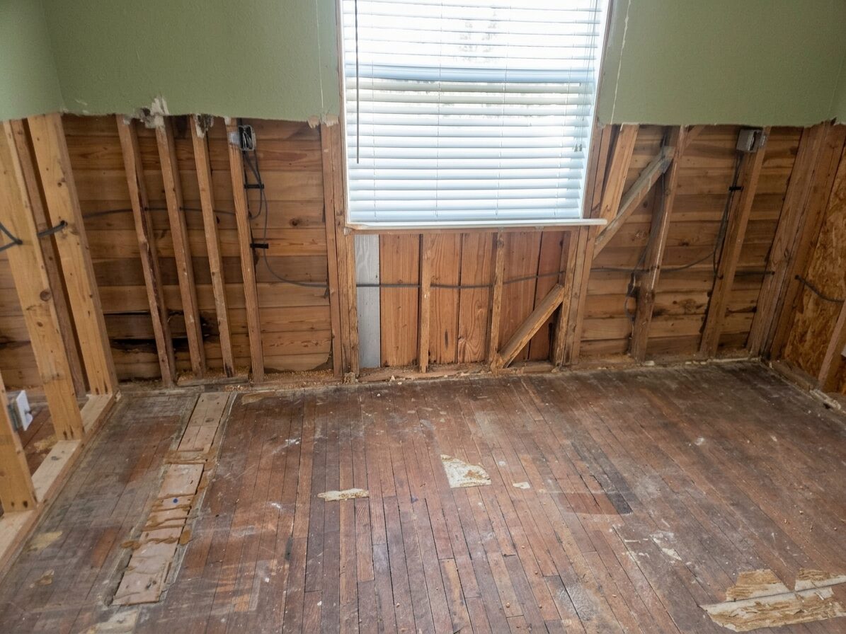 The flood-gutted interior of the Isla Breeze bungalow, opened to the studs and subfloor