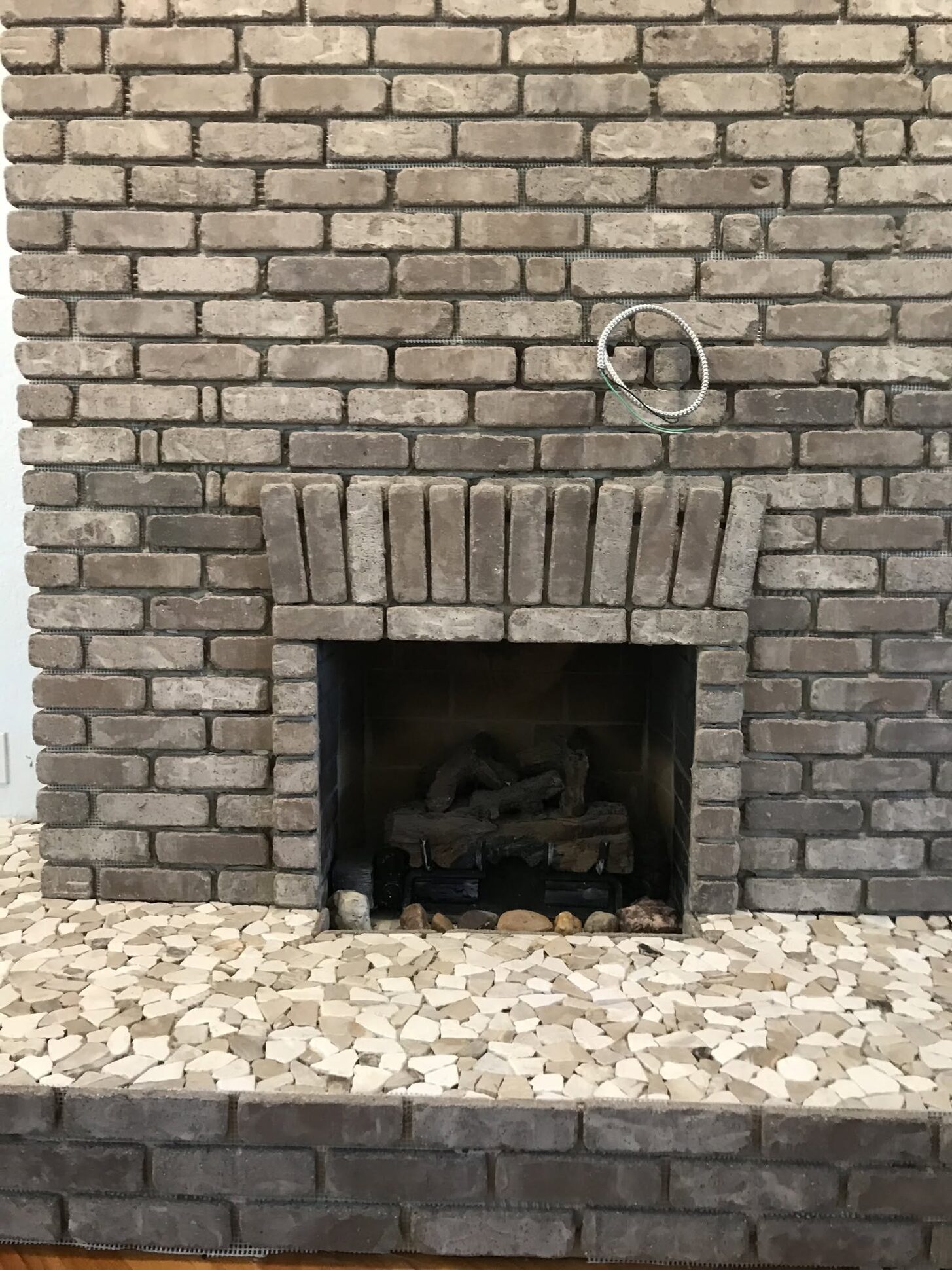 A restored brick fireplace in a Reliant remodel